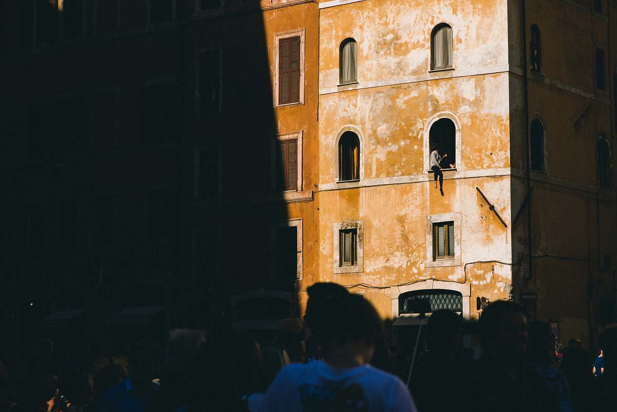 building person sitting on building window italy