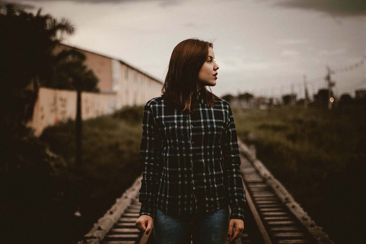 person woman standing on train rail track human