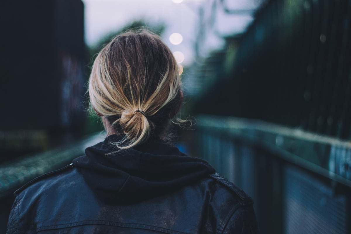person woman wearing black jacket walking human