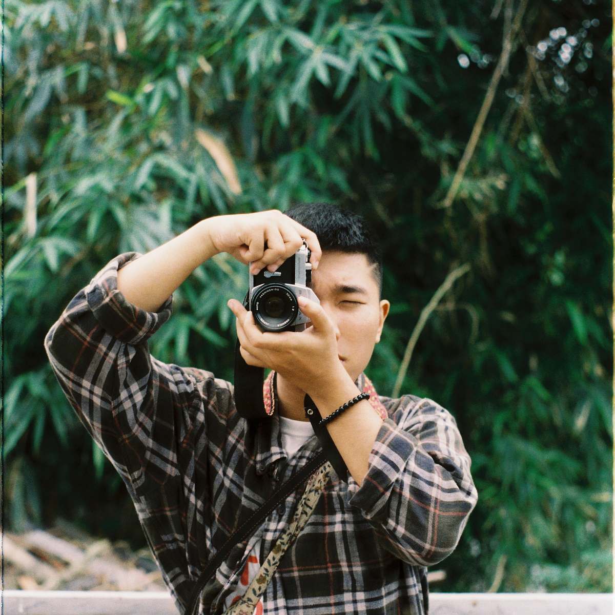 human man holding black and gray camera during daytime camera