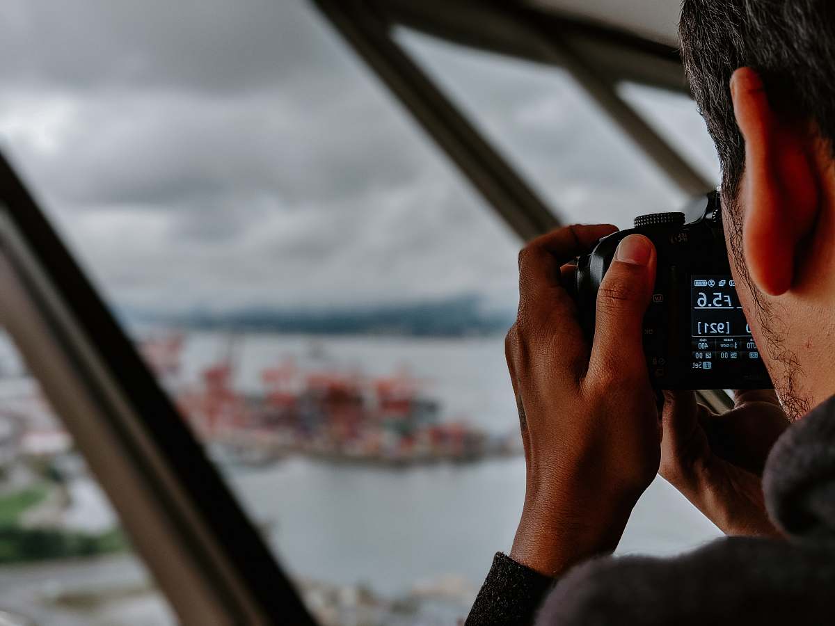 human man taking photo of island photographer