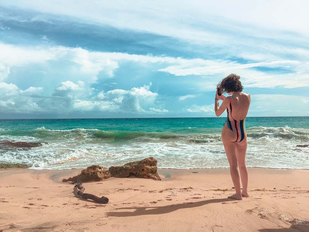 human rule of thirds photography of woman standing on beach photo