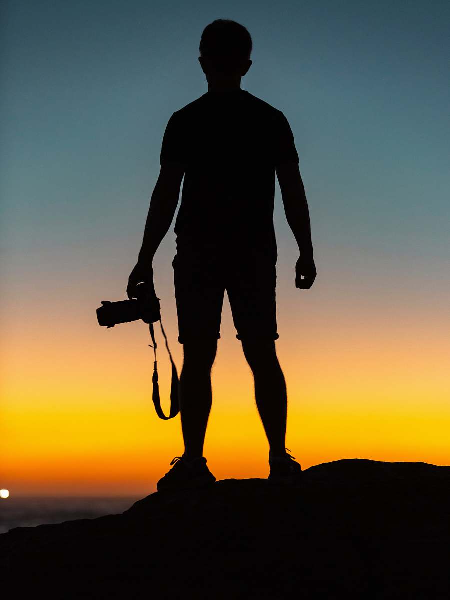 silhouette silhouette of man standing on cliff human