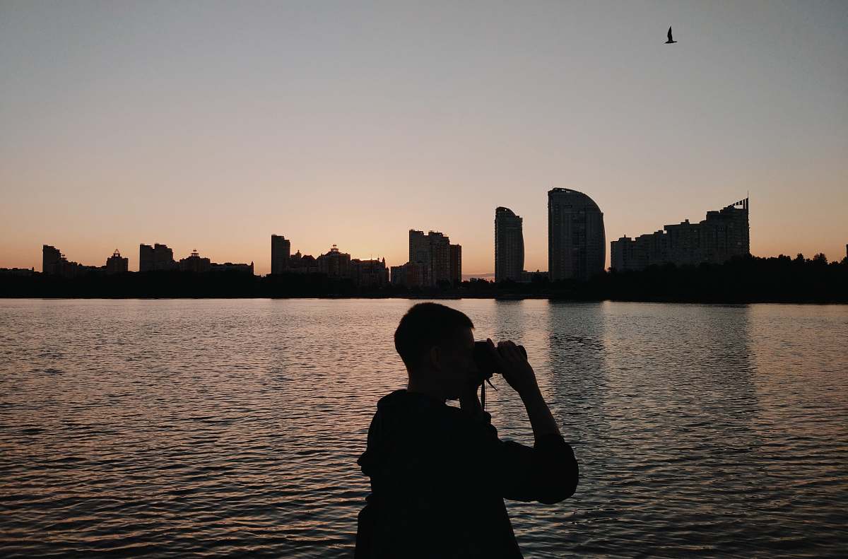 human silhouette of person using binoculars photographer