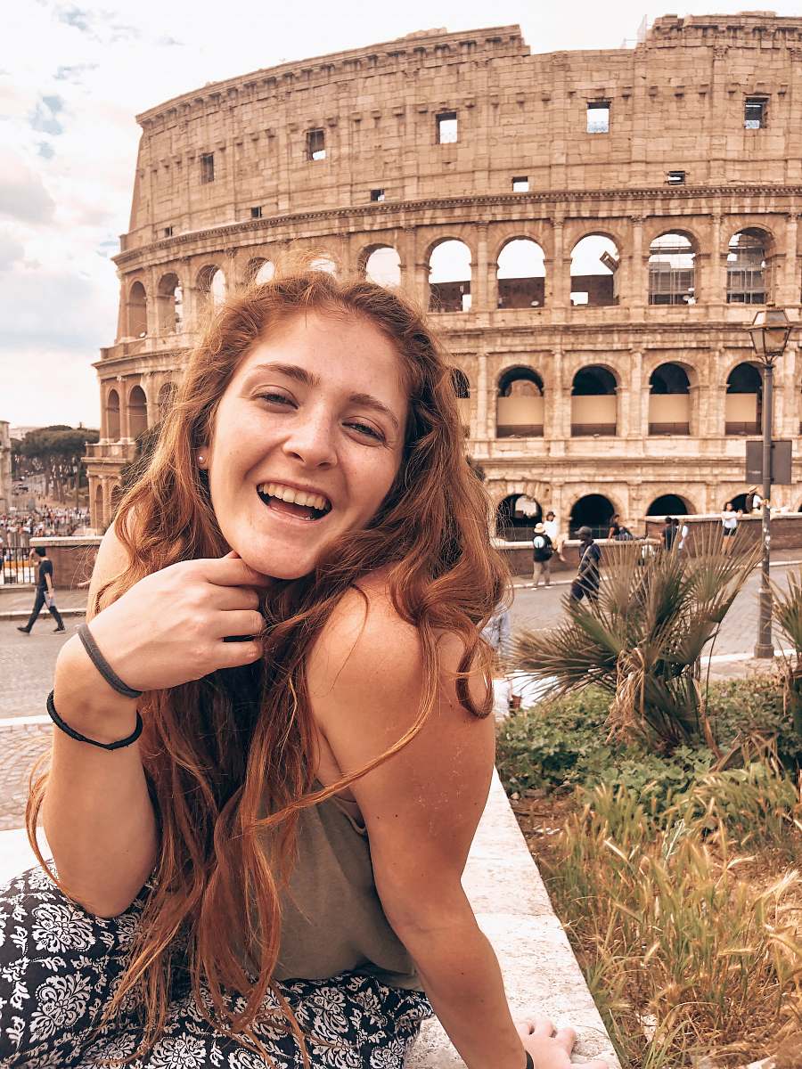 human woman smiling near coliseum face