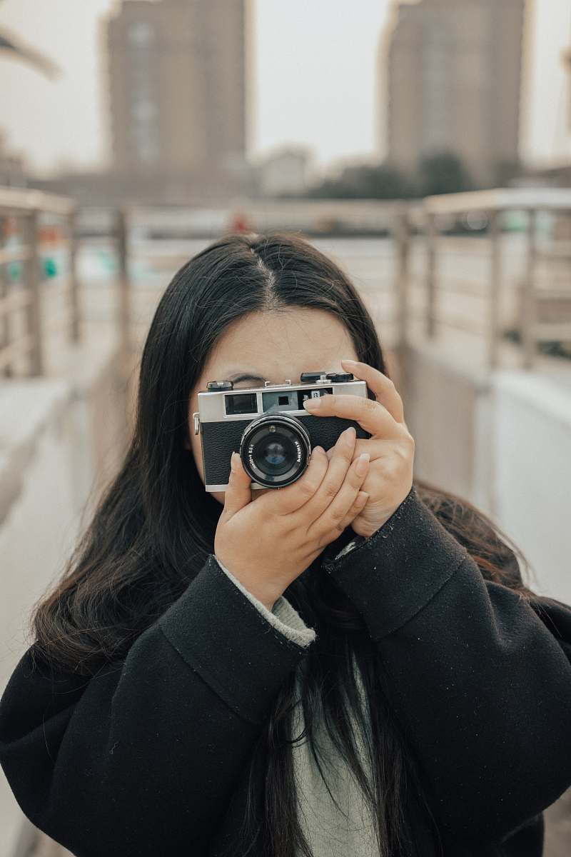 human woman wearing black camera camera