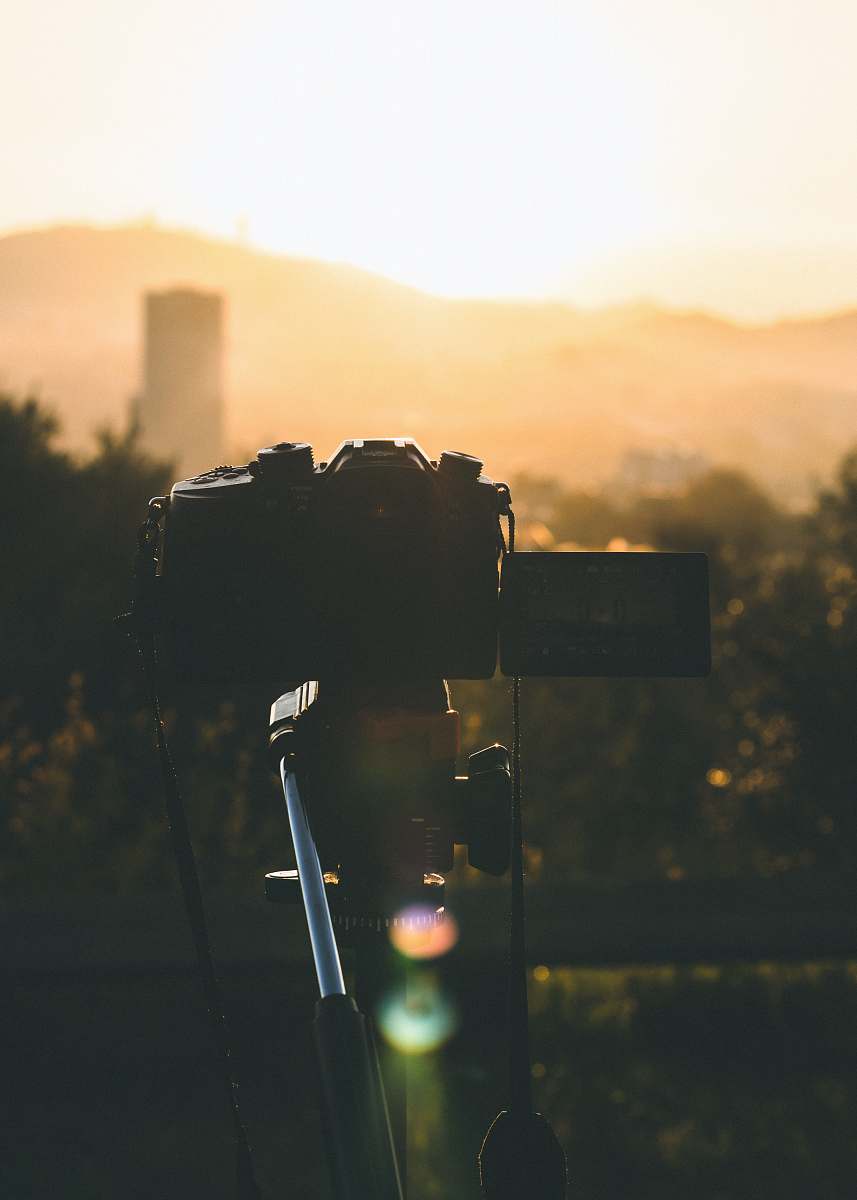 photographer black camera during golden hour photography