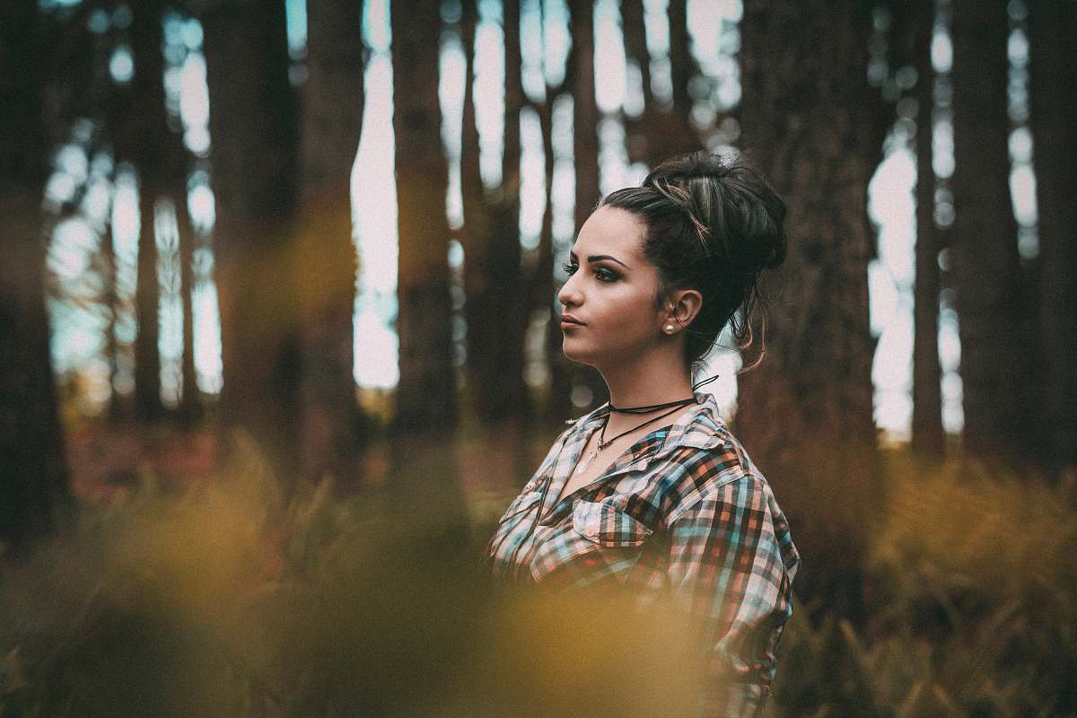 girl woman standing beside tree in forest female
