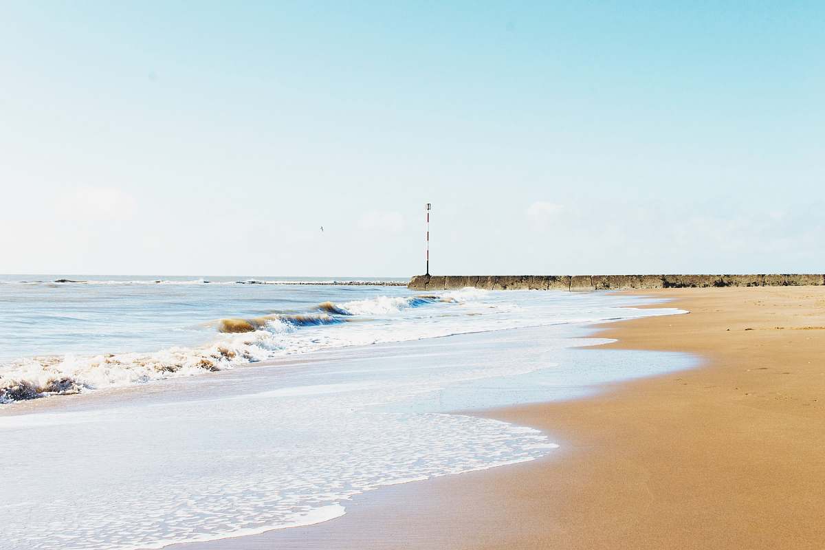 sea brown sand beach and ocean waves during daytime coast