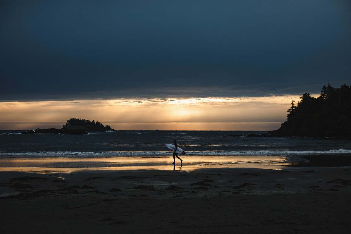 ocean person holding surfboard walking on seashore water