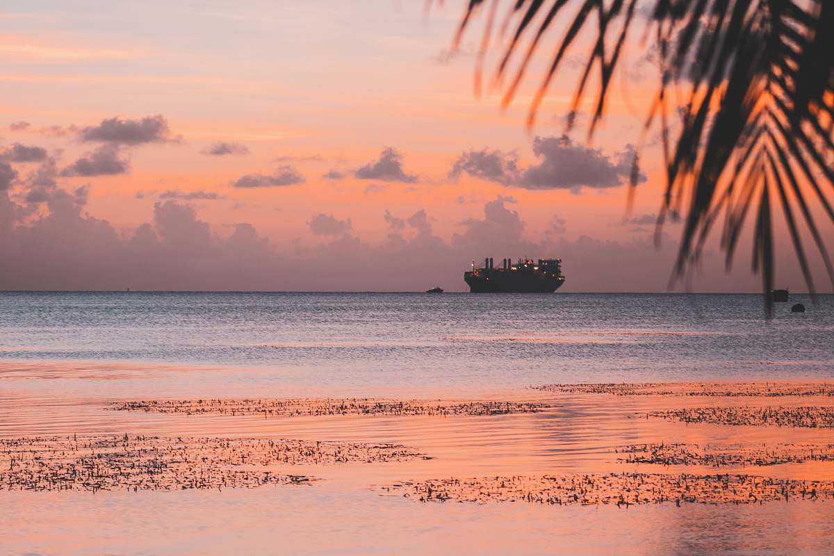 ocean silhouette of ship on body of water during golden hour sea