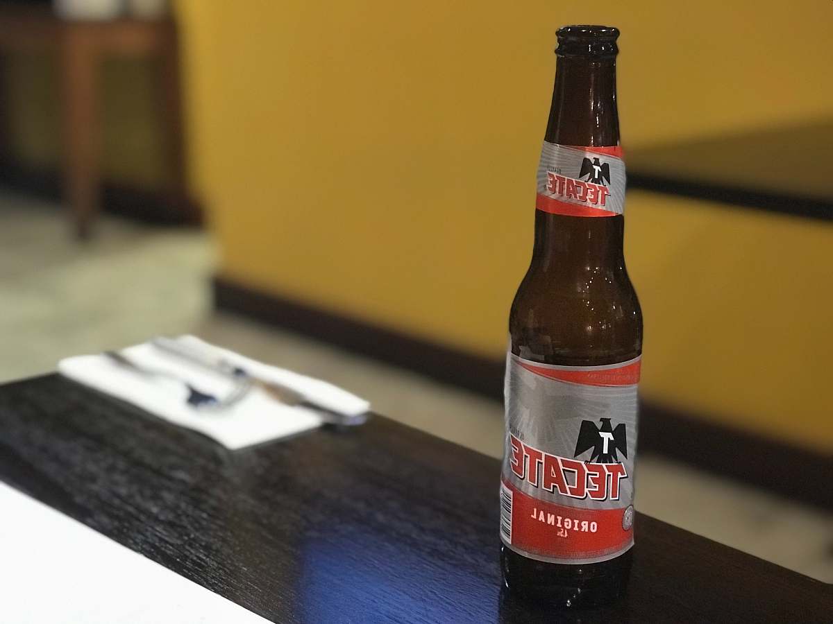 alcohol Tecate beer bottle on coffee table beverage