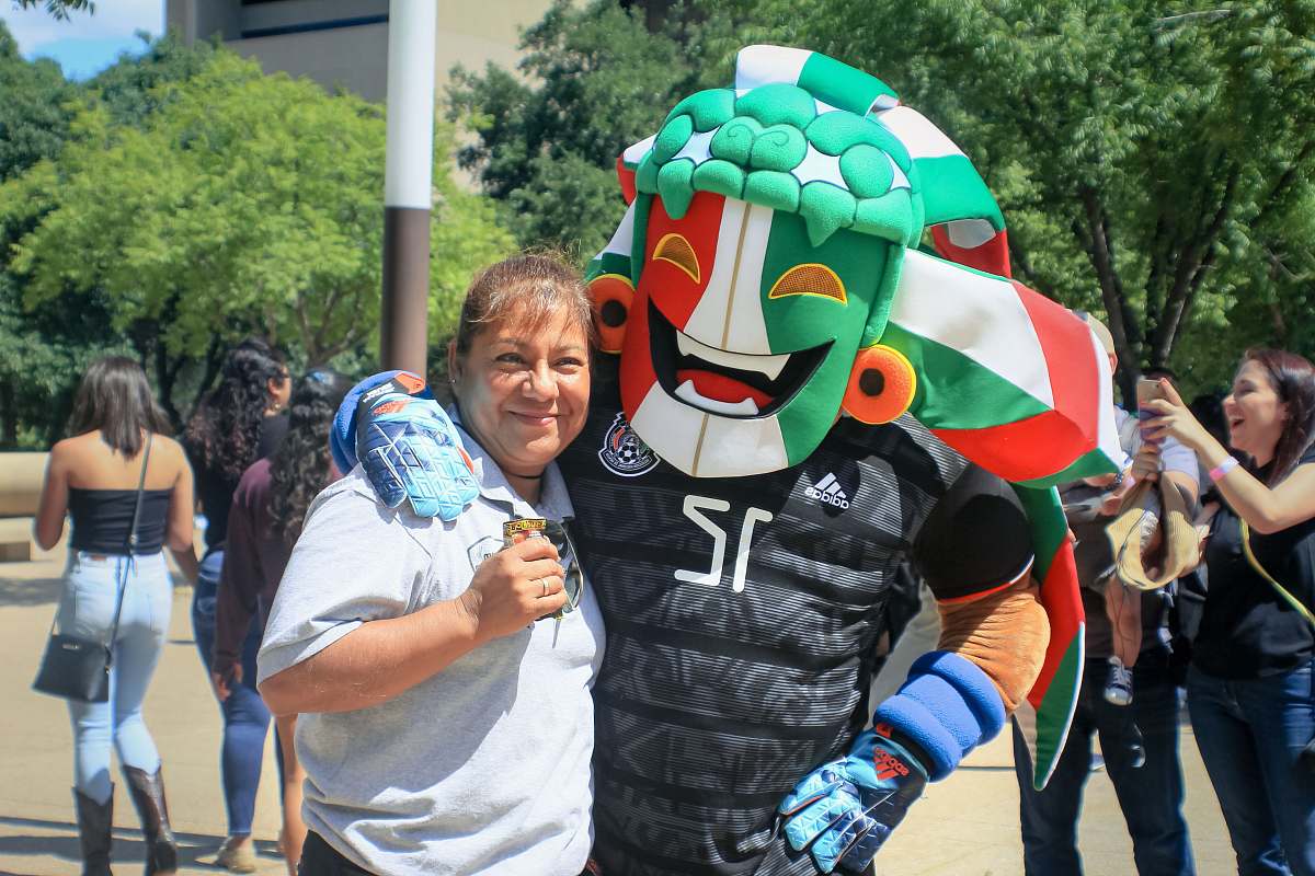 human woman standing beside sports mascot apparel
