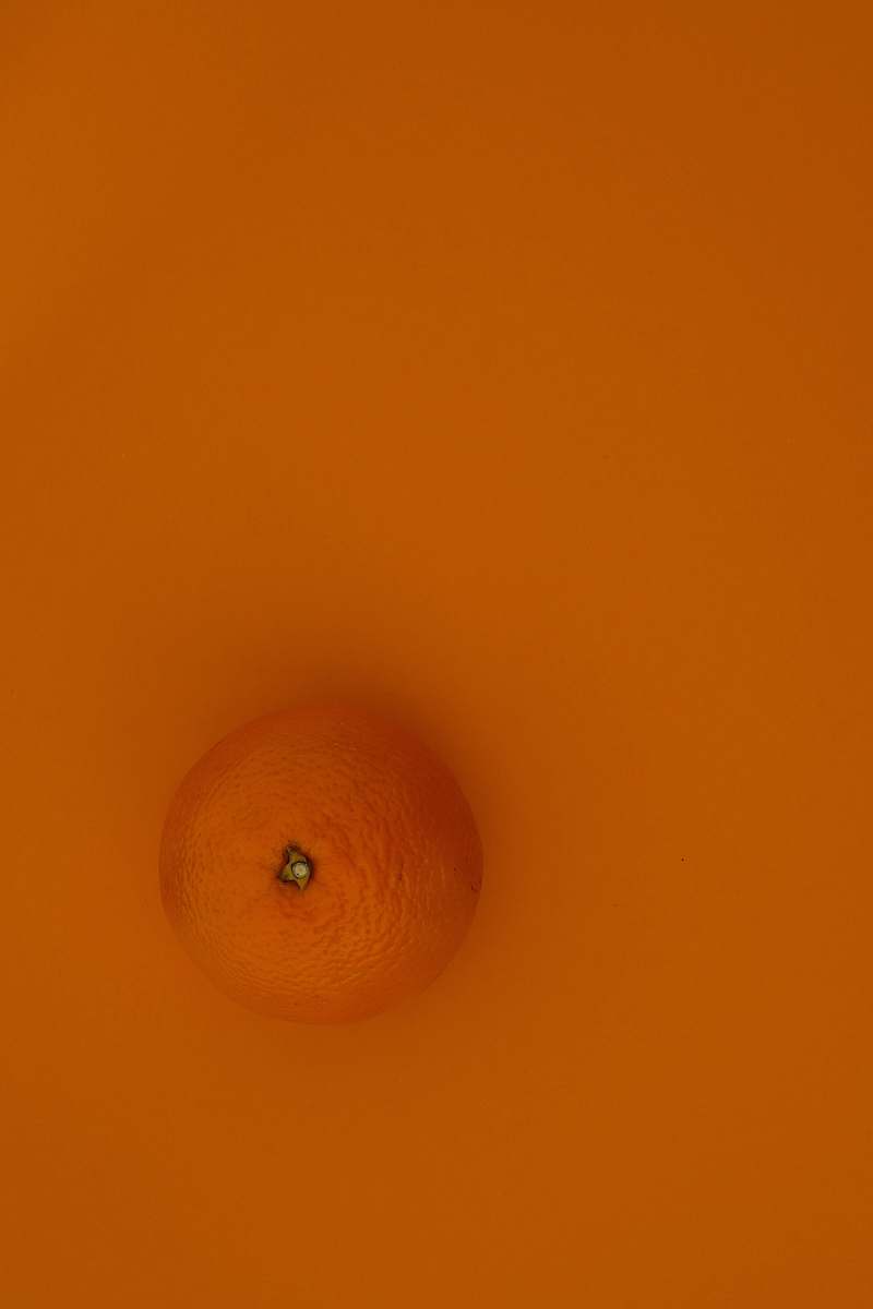 fruit orange fruit on yellow surface citrus fruit