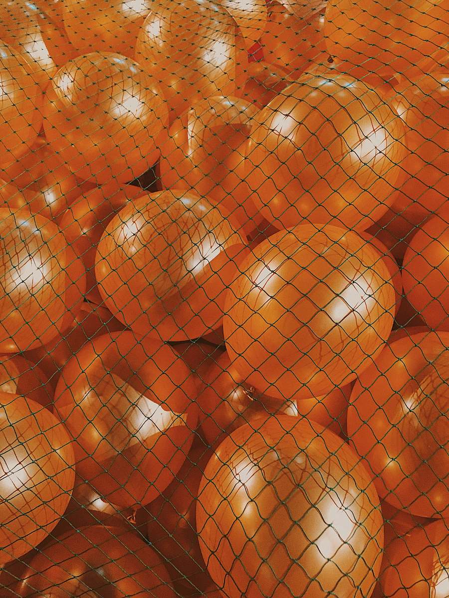 food red and gold baubles on brown wooden surface citrus fruit