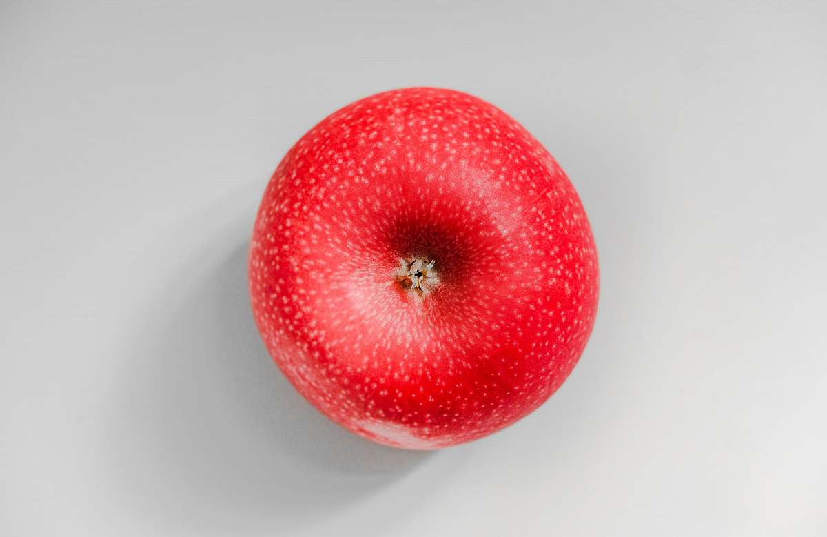 food red apple fruit on white surface Apple