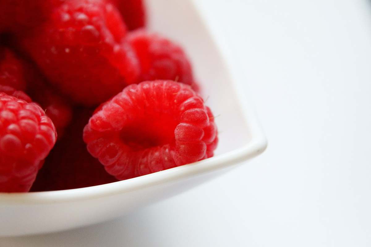raspberry red raspberry on white ceramic bowl food