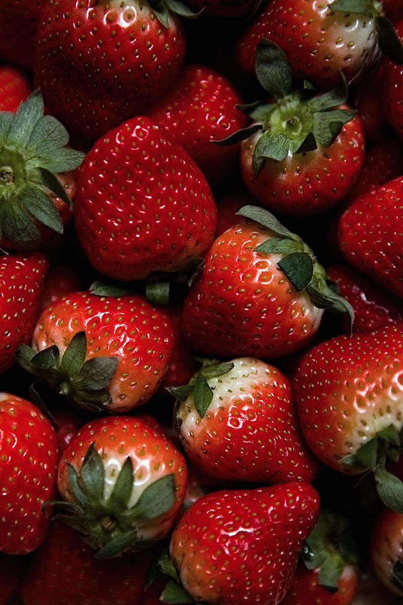 food red strawberries on green leaves plant