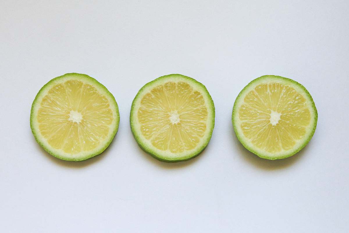food sliced lemon on white surface citrus fruit