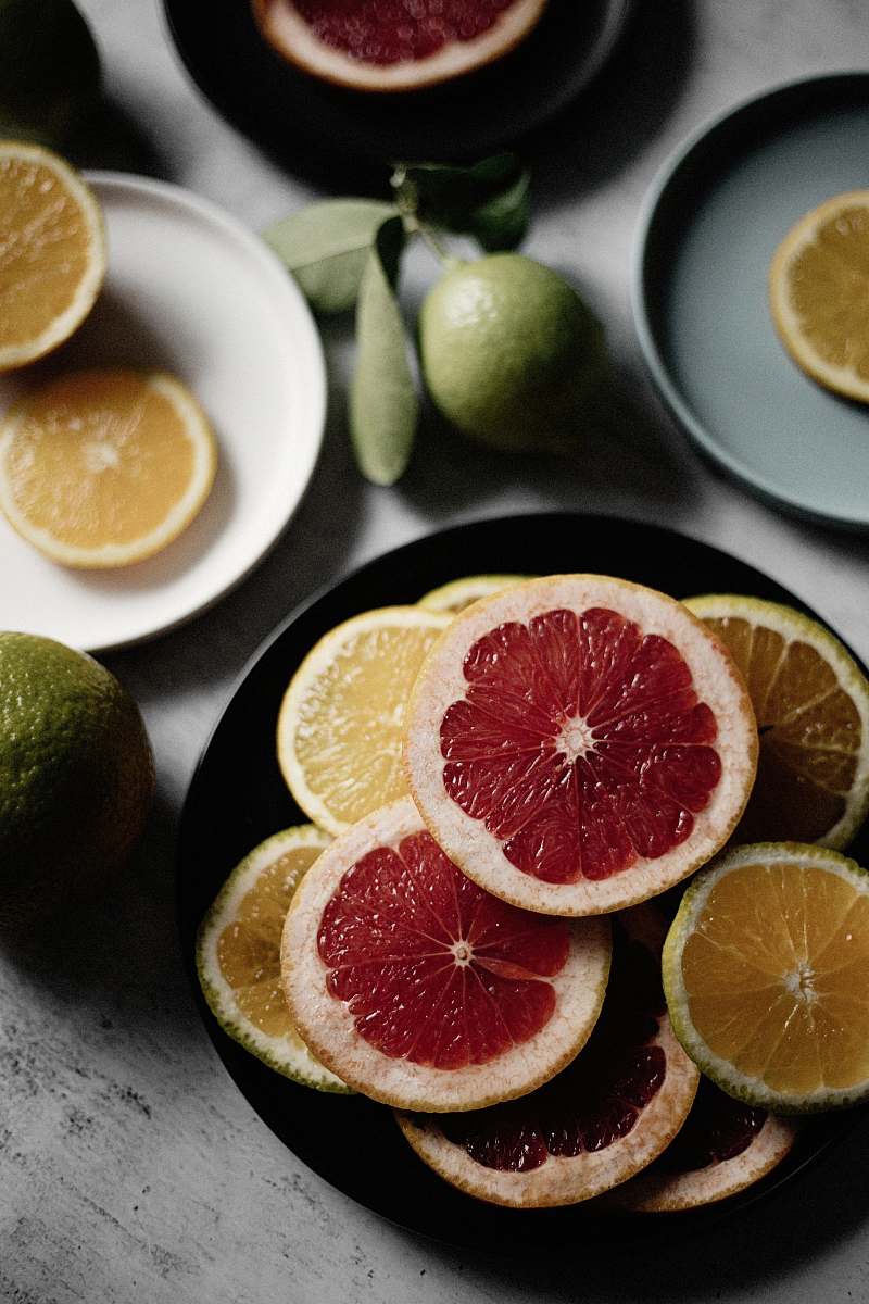food sliced orange fruit on black ceramic plate citrus fruit