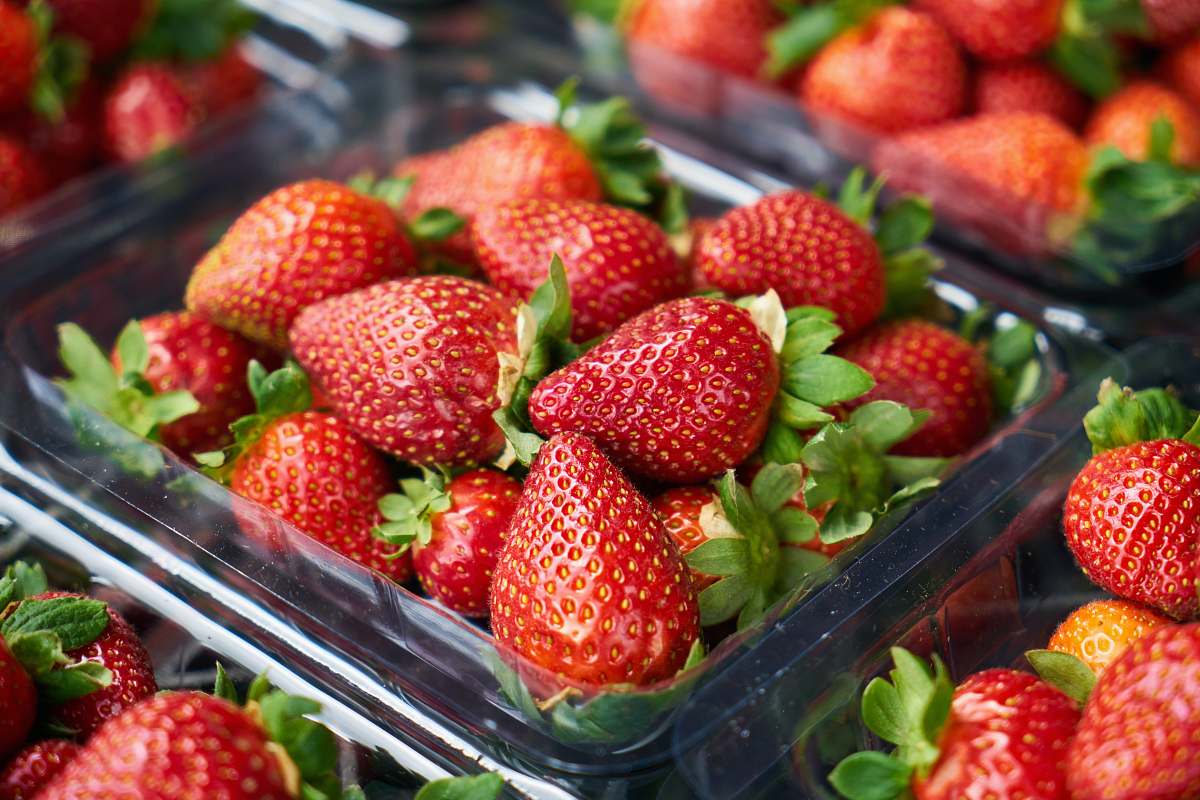 food strawberries on clear plastic container strawberry