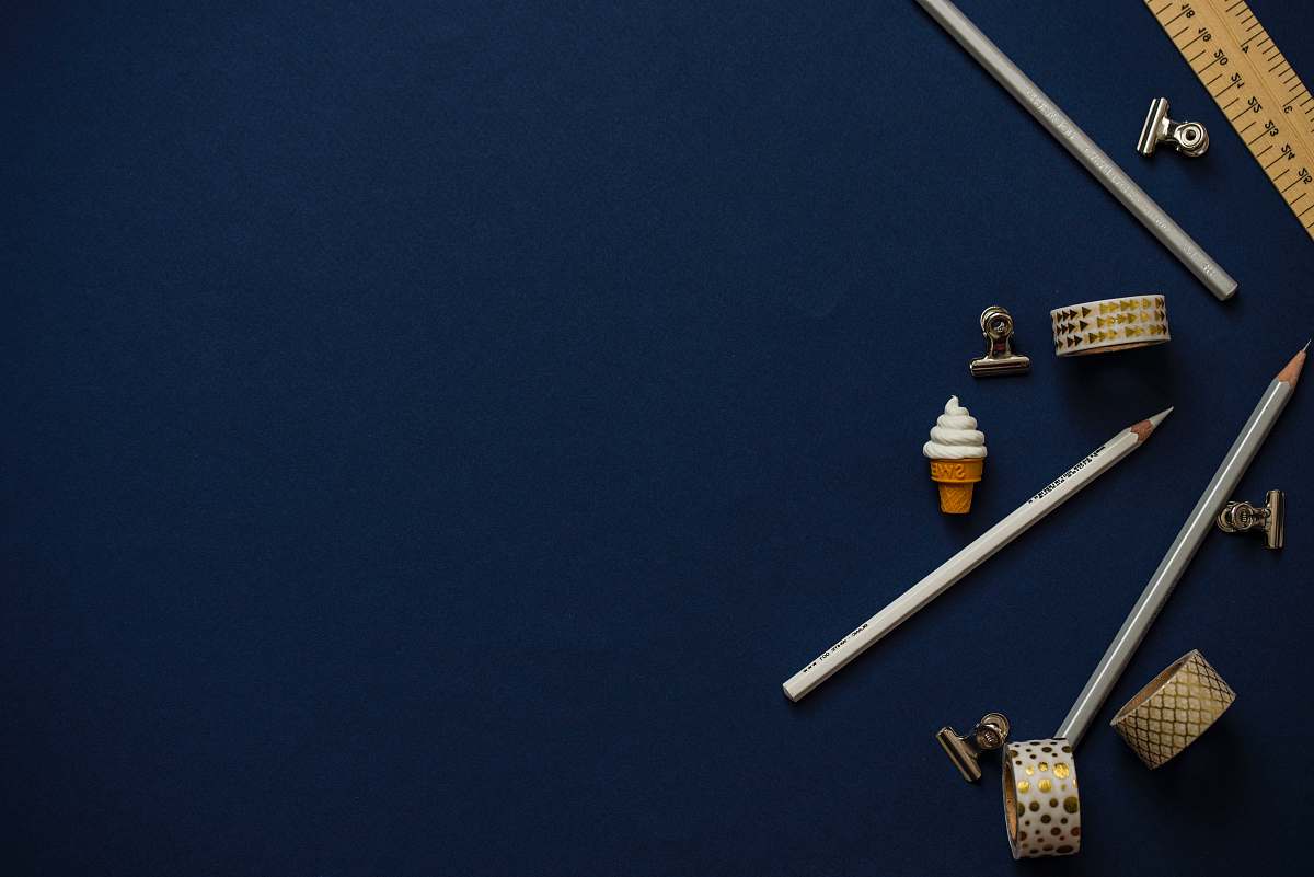 office pencils on blue table space