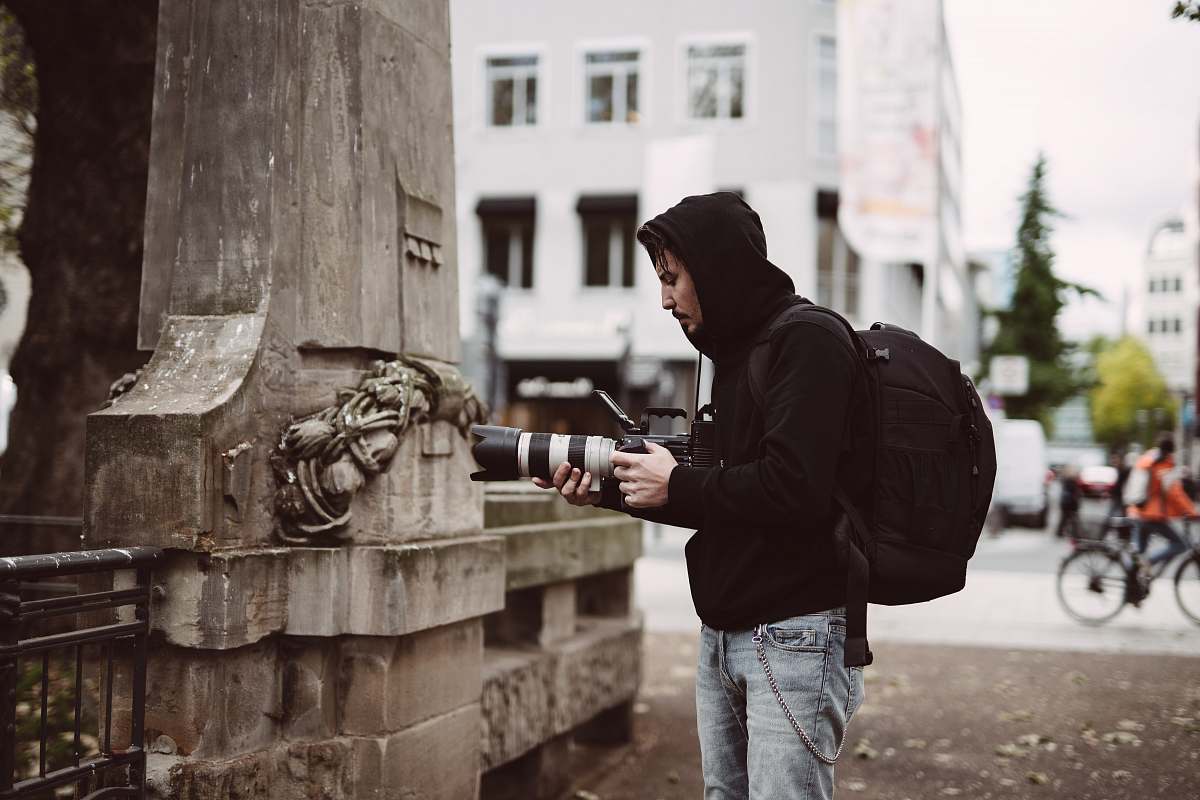 bike man holding black DSLR camera transportation