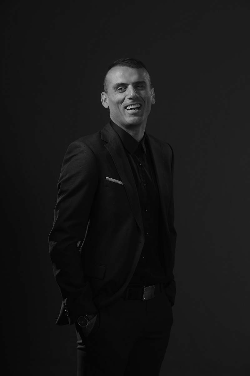 apparel grayscale photography of man wearing black tuxedo suit