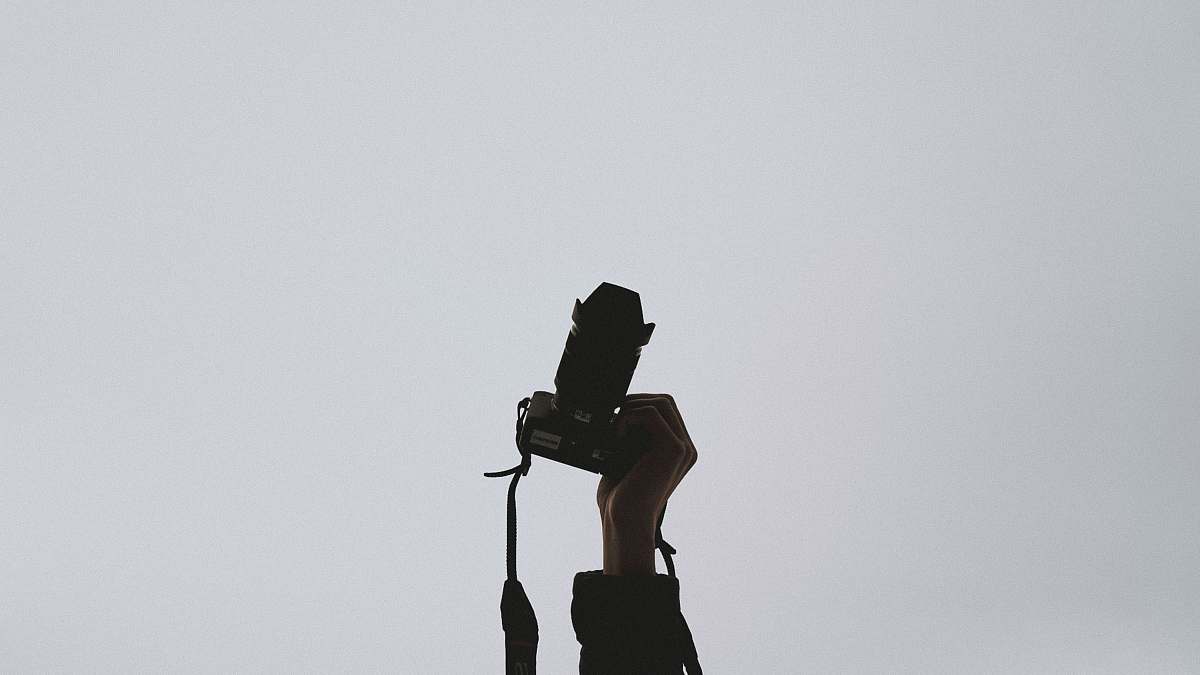 photo person holding camera photography
