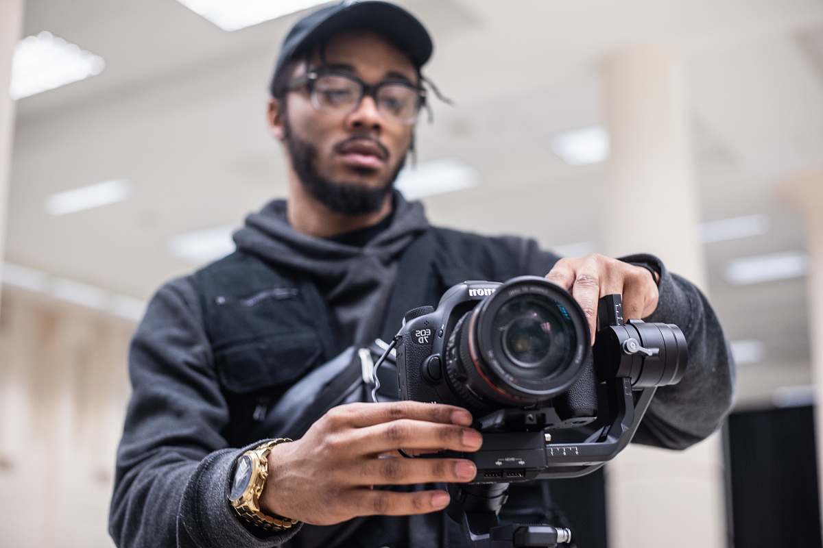 human man using black Canon DSLR camera person