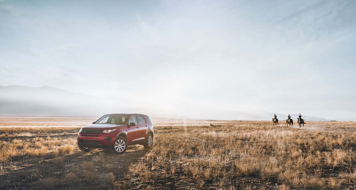suv red SUV on field and three person riding horse field