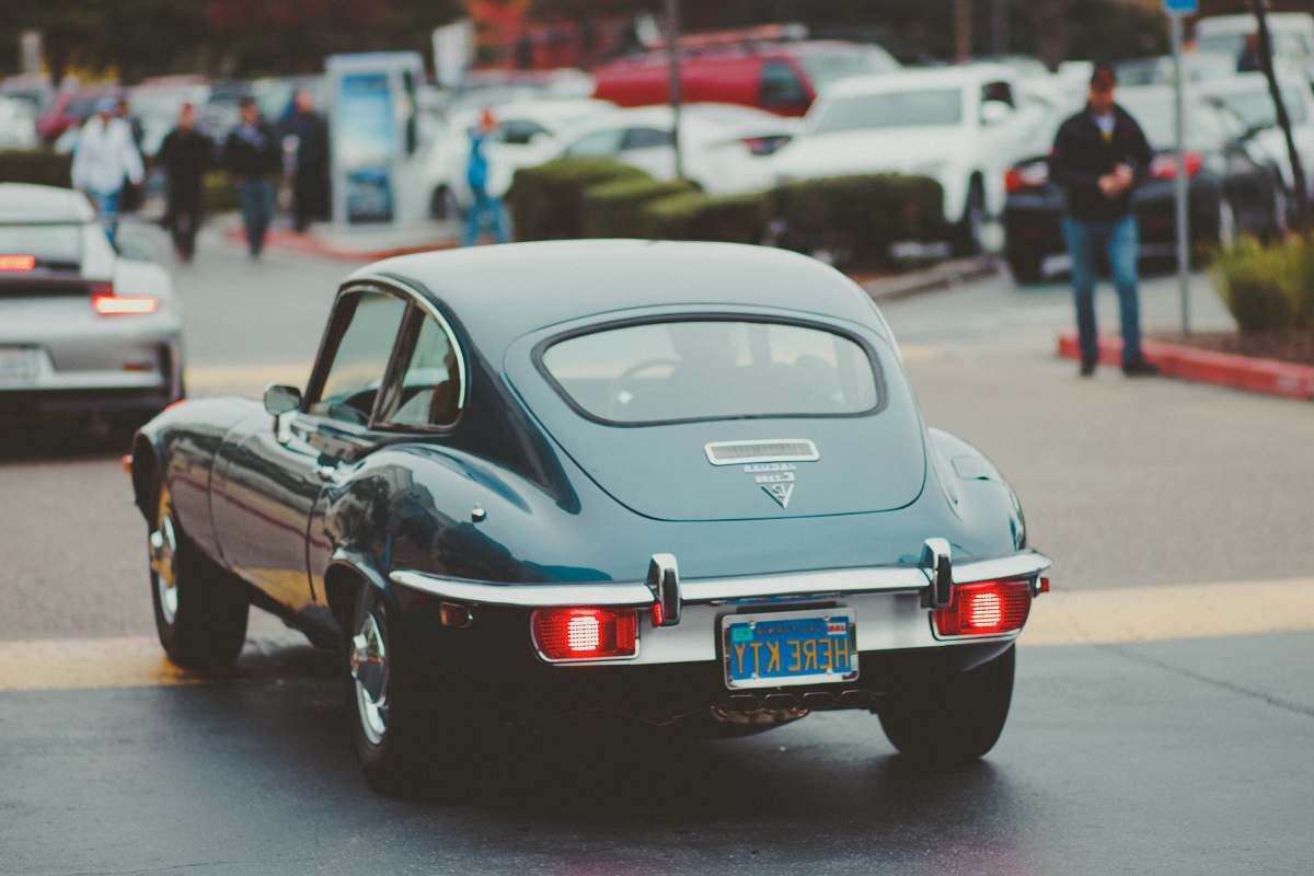 automobile teal coupe passing by in street transportation