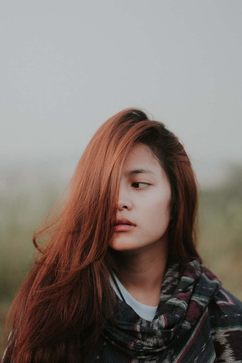 person woman wearing black and multicolored aztec top human