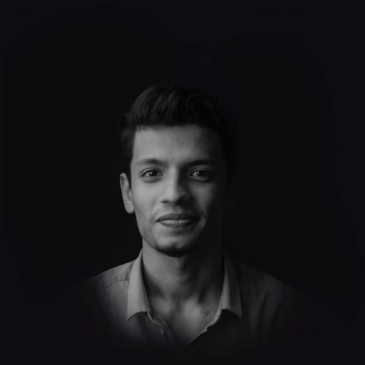 face greyscale photo of smiling man wearing collared shirt black-and-white