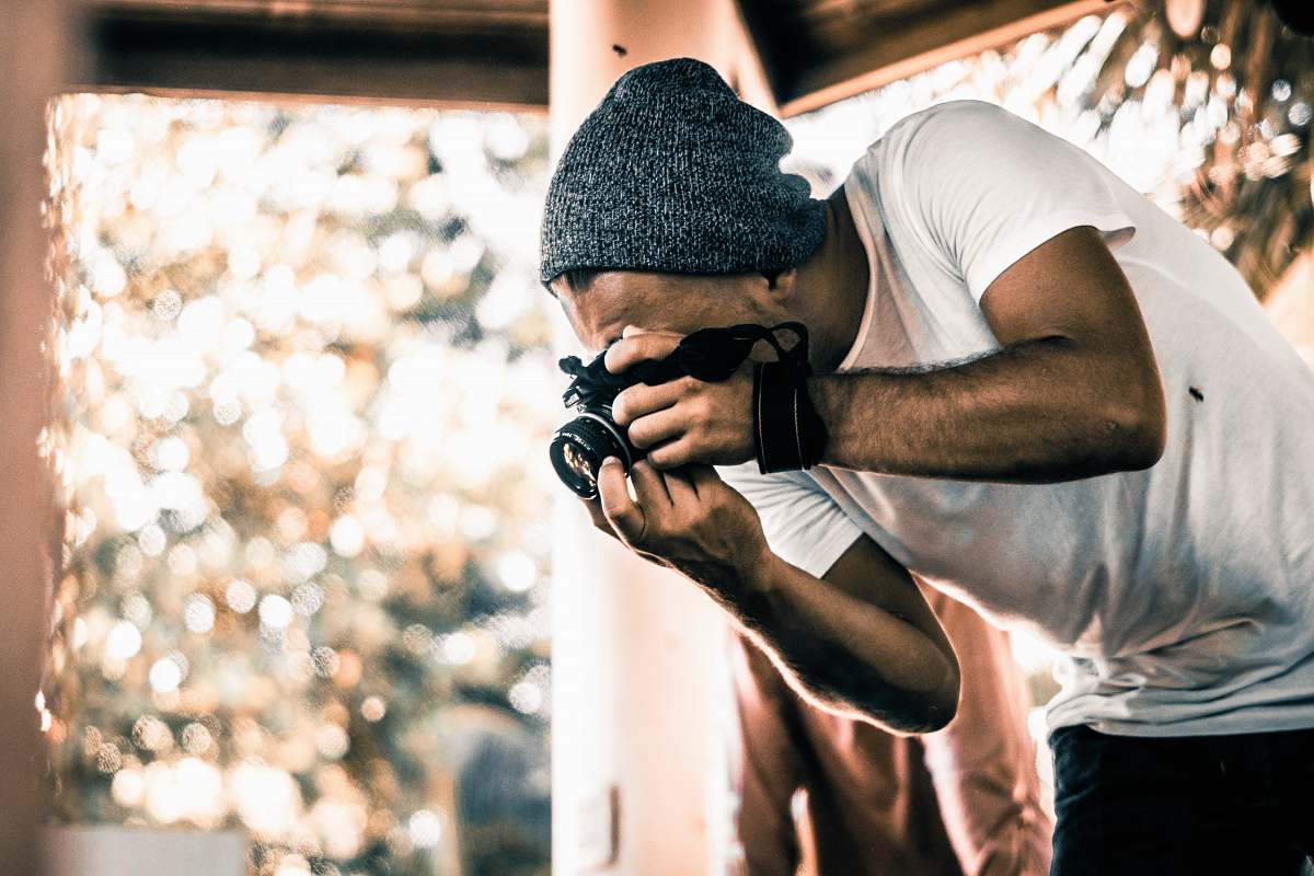 person man holding camera during daytime photographer