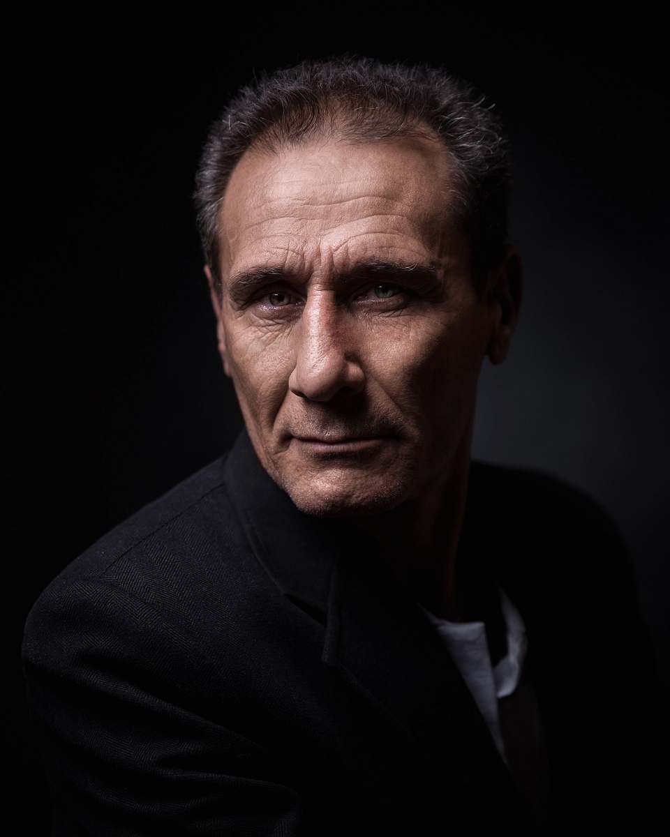 person man in black suit jacket face