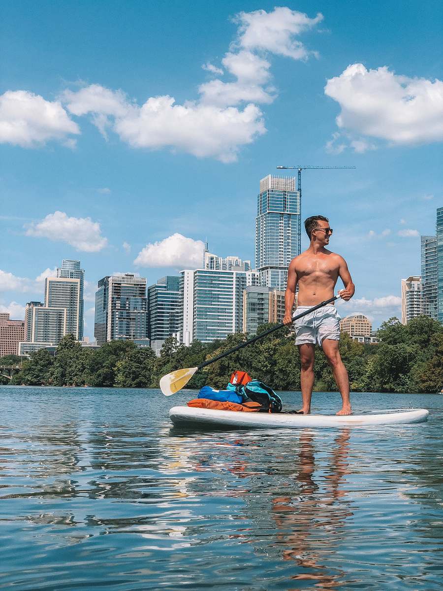 person man in white shorts on paddle board people