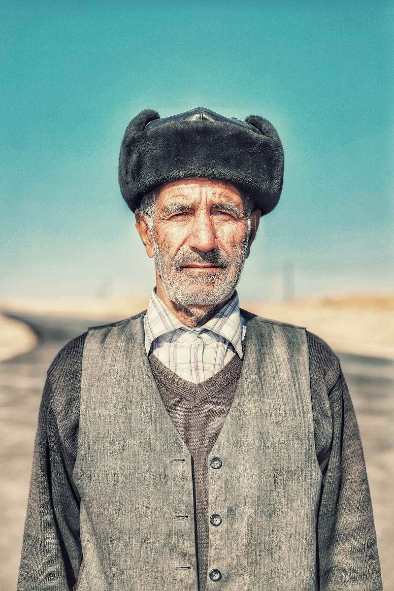 clothing man wearing hat while standing on open field apparel