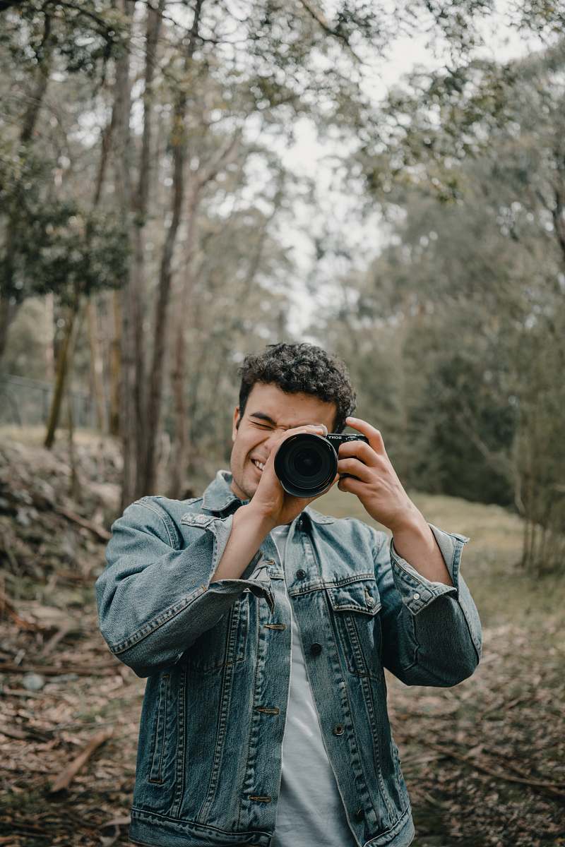 person man wears blue denim jacket camera