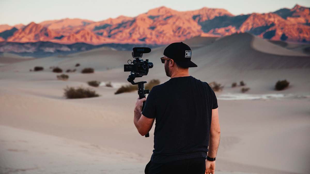 person man with gimbal in desert soil