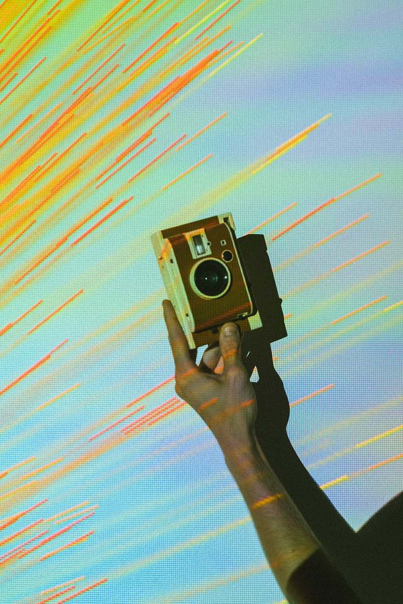 person person showing brown and white vintage camera photographer