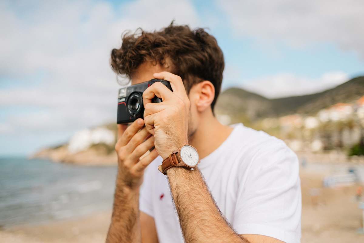 person shallow focus photography unknown person using black camera outdoors camera