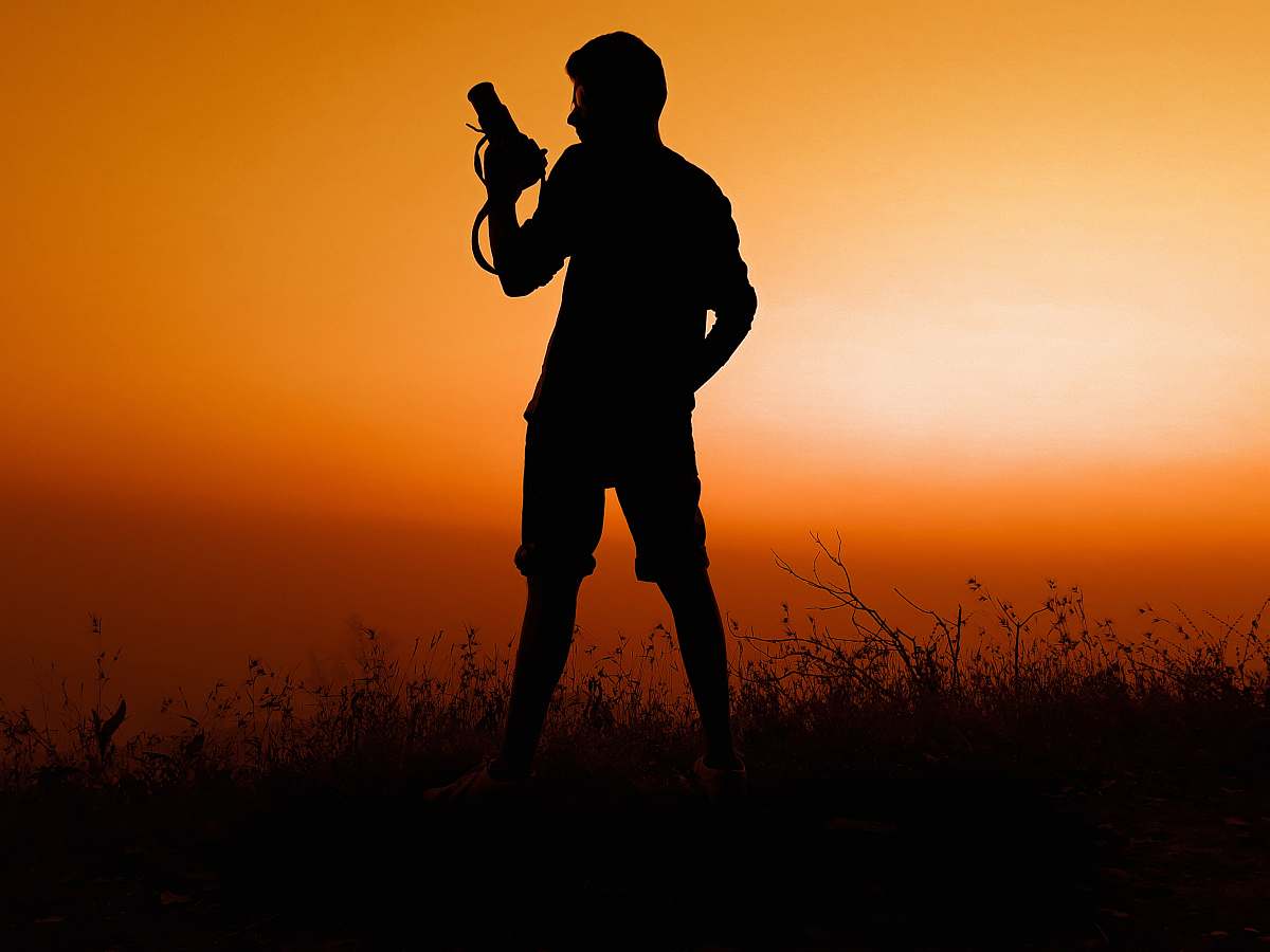 person silhouette of man holding pistol photo
