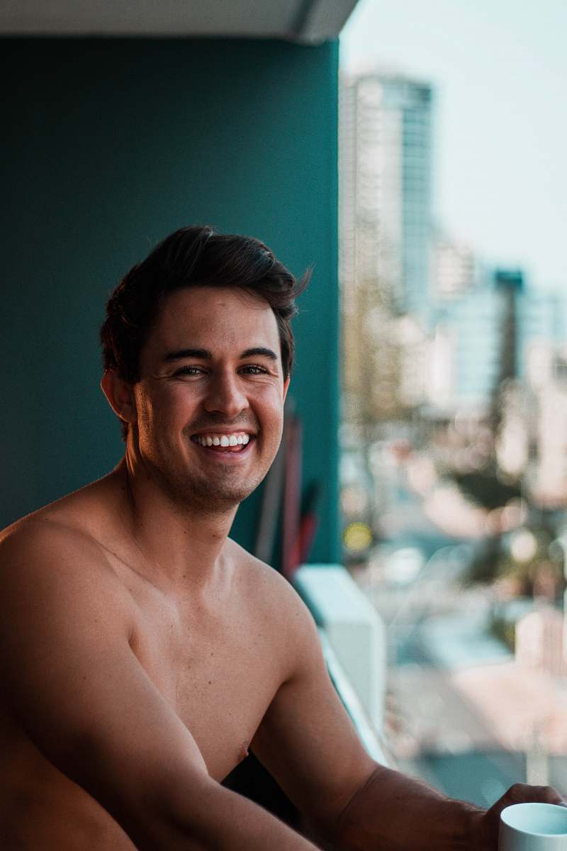 person topless man smiling on focus photography face