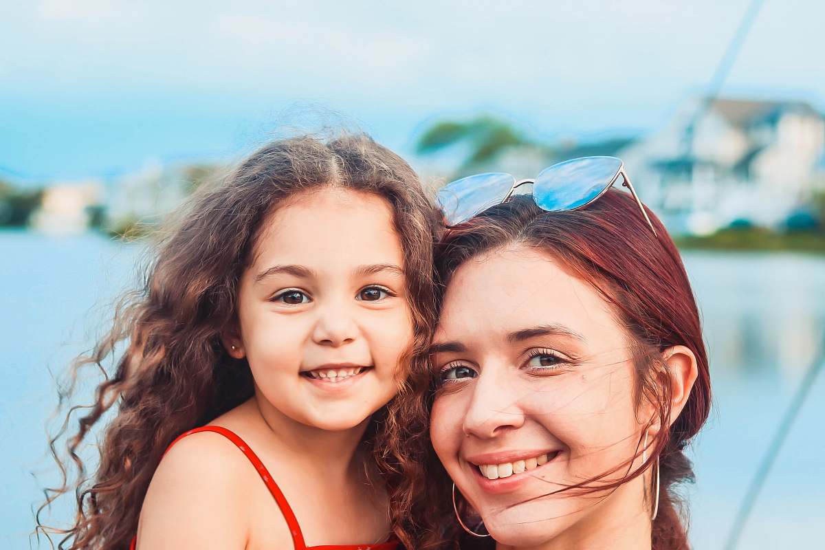 person woman carrying girl face