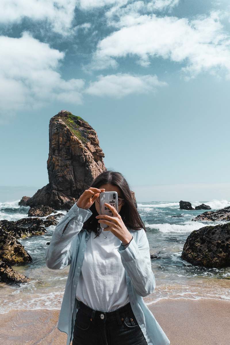 person woman standing near shore promontory