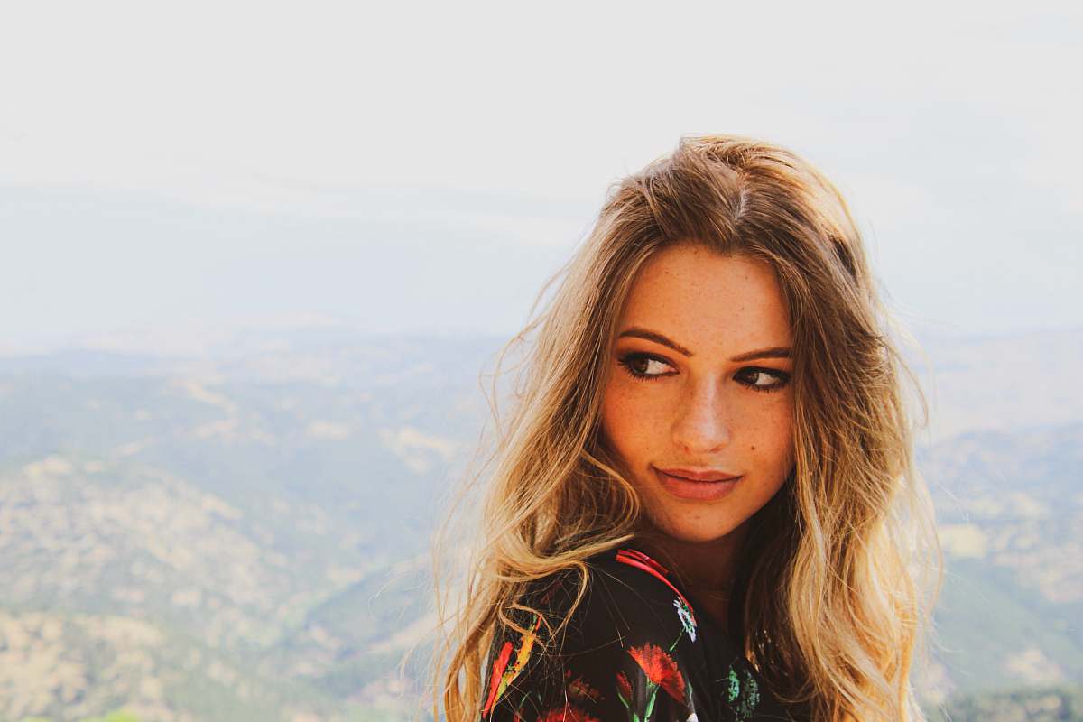 Capture the essence of serenity with this stunning image of a young woman standing on a picturesque hill. Dressed in a vibrant floral dress, she exudes confidence and grace against a breathtaking backdrop of nature. This captivating scene is perfect for a variety of uses, including fashion blogs, youth empowerment campaigns, outdoor lifestyle promotions, and travel guides. Whether you're aiming to inspire, advertise, or beautify your content, this image will add a touch of elegance and joy.