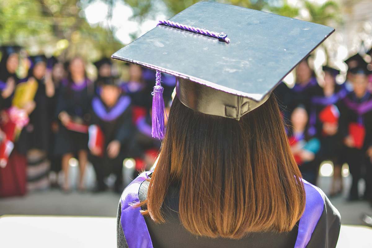 person woman wearing academic cap and dress selective focus photography graduation