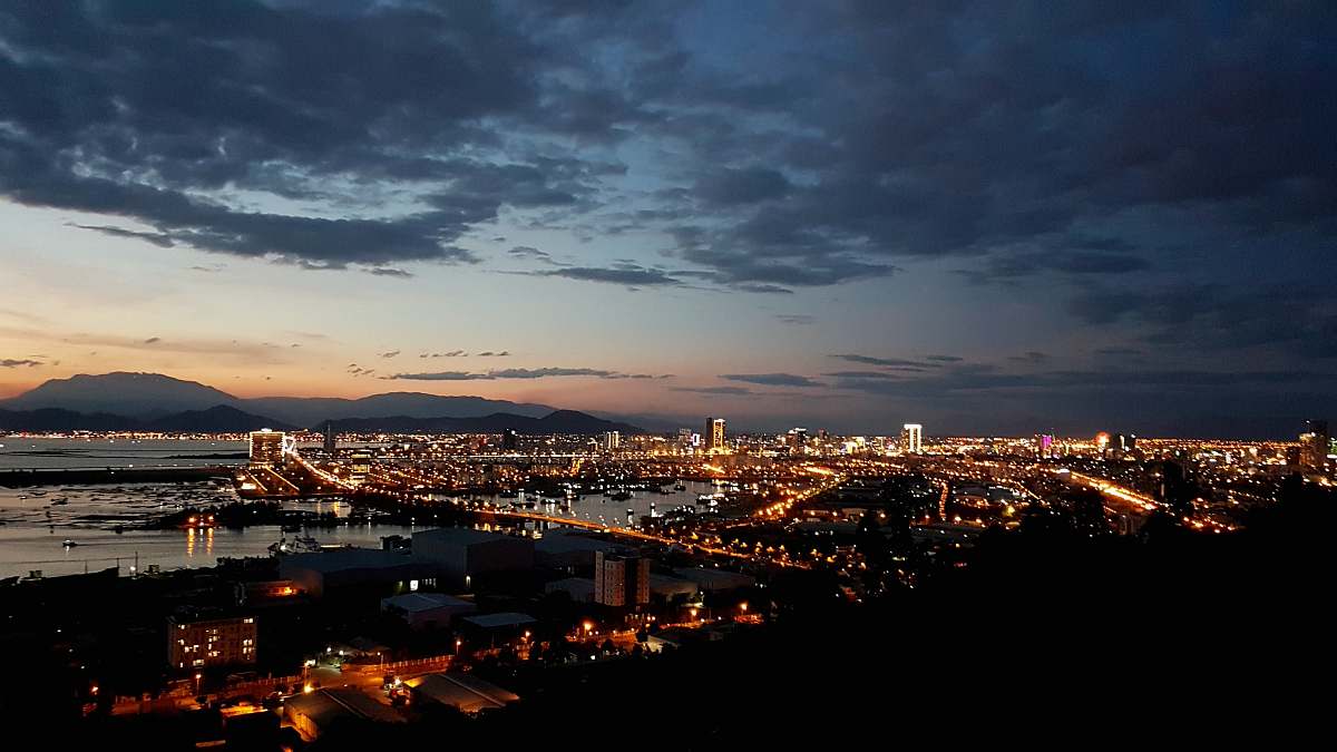nature city with high-rise buildings viewing sea during night time outdoors