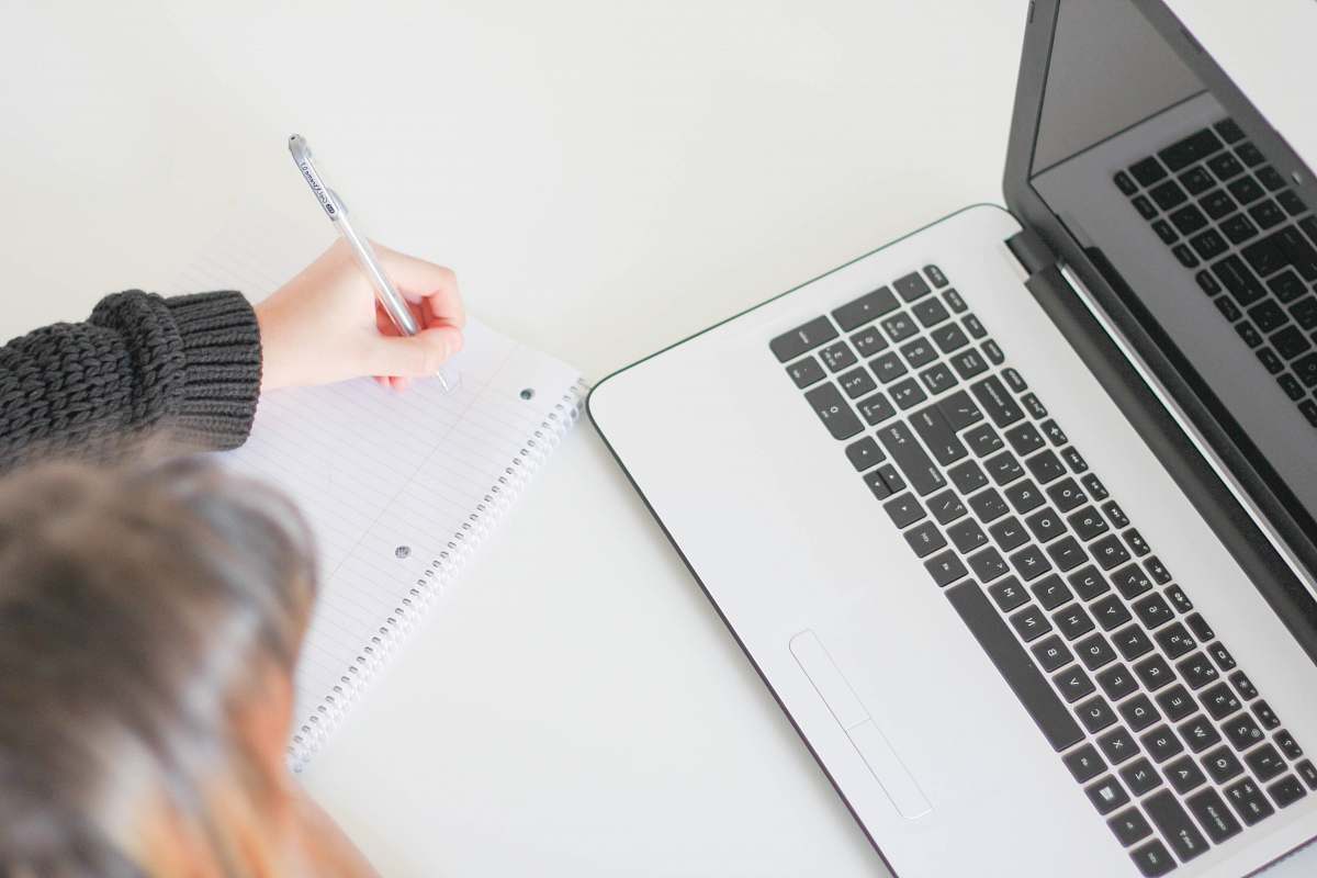 computer woman writing on notebook work